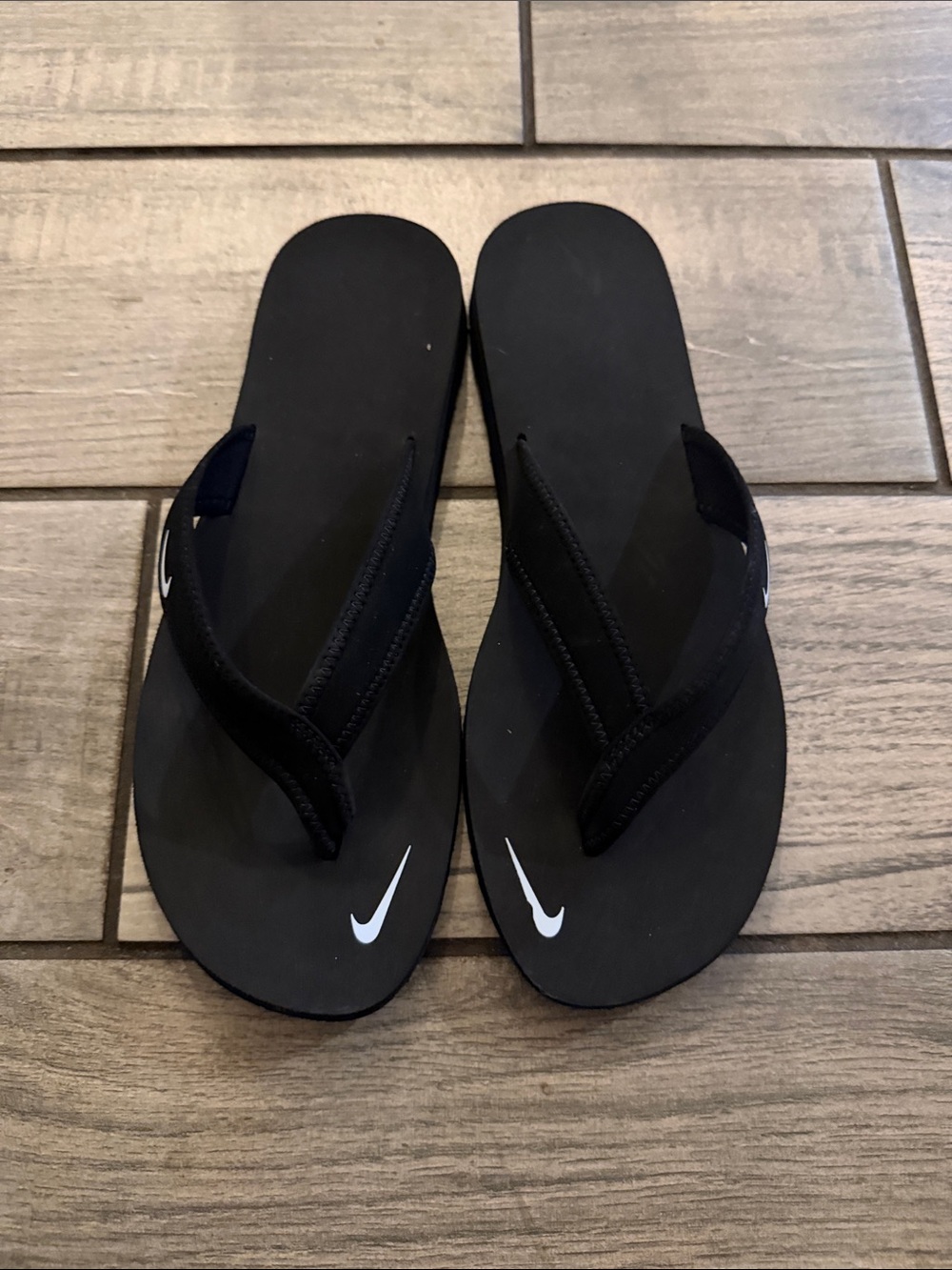 Women’s black Nike flip-flop shoes